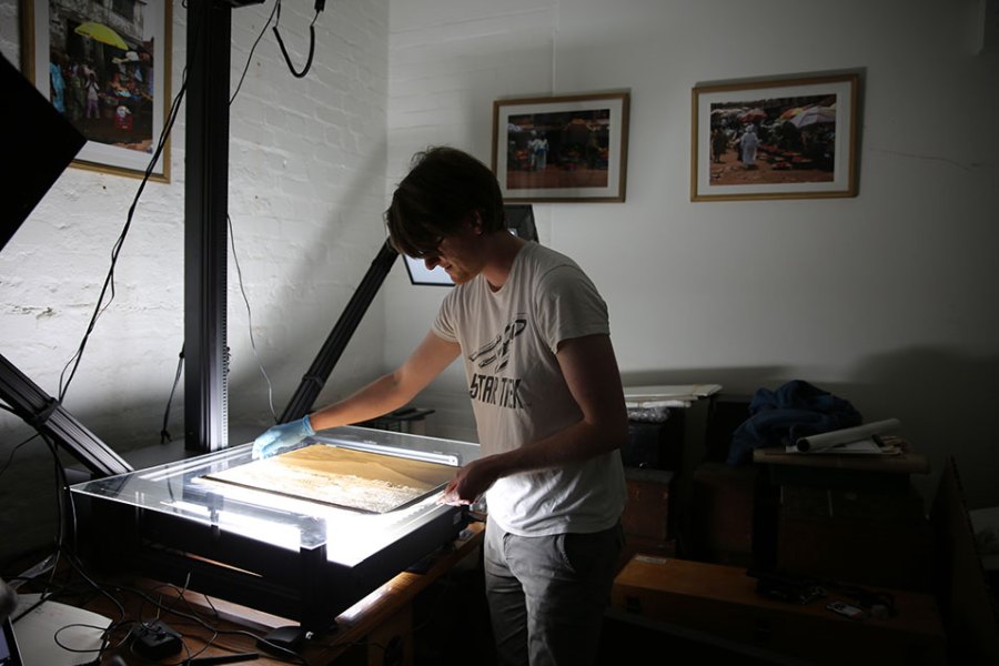 British Museum assistant collections manager Jonny Mortemore using the glass plate negative scanner. Courtesy of the Trustees of the British Museum