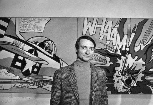 Roy Lichtenstein in front of one of his paintings at the Tate Gallery, London.