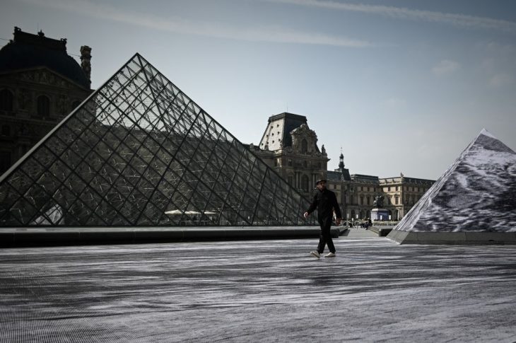 Jean Rene, aka JR walks in the Cour Napoleon of the Louvre Museum as part of the 30th anniversary celebrations of the Louvre Pyramid, Photo: Philippe Lopez/AFP/Getty Images