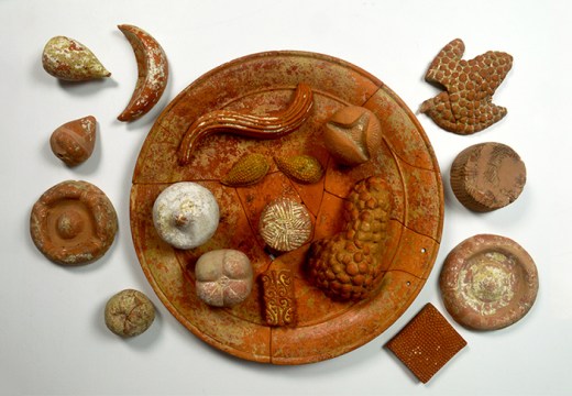 Terracotta votive food: pomegranates (open and closed); grapes; figs; almonds; cheeses; focaccia;