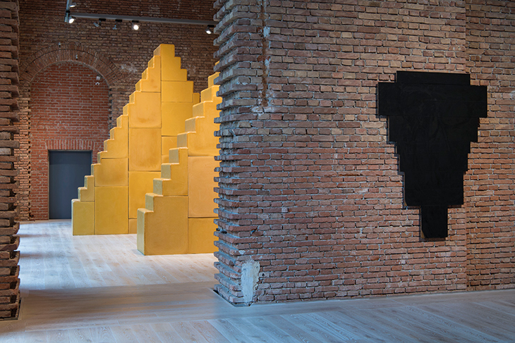 Installation view of Without Beginning and Without End (2005-18) by Wolfgang Laib and Cross, Black, on Light Brown (1969) by Arnulf Rainer, in the north wing of the Herrenchiemsee Palace on the island of Herreninsel. 