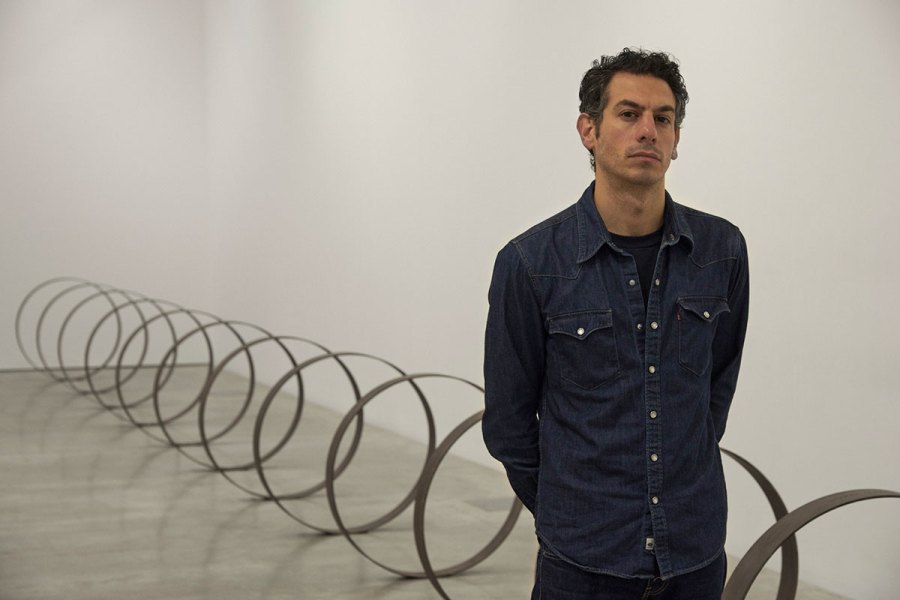 Rayyane Tabet in front of Steel Rings (2013–), from the series The Shortest Distance Between Two Points (2007–).