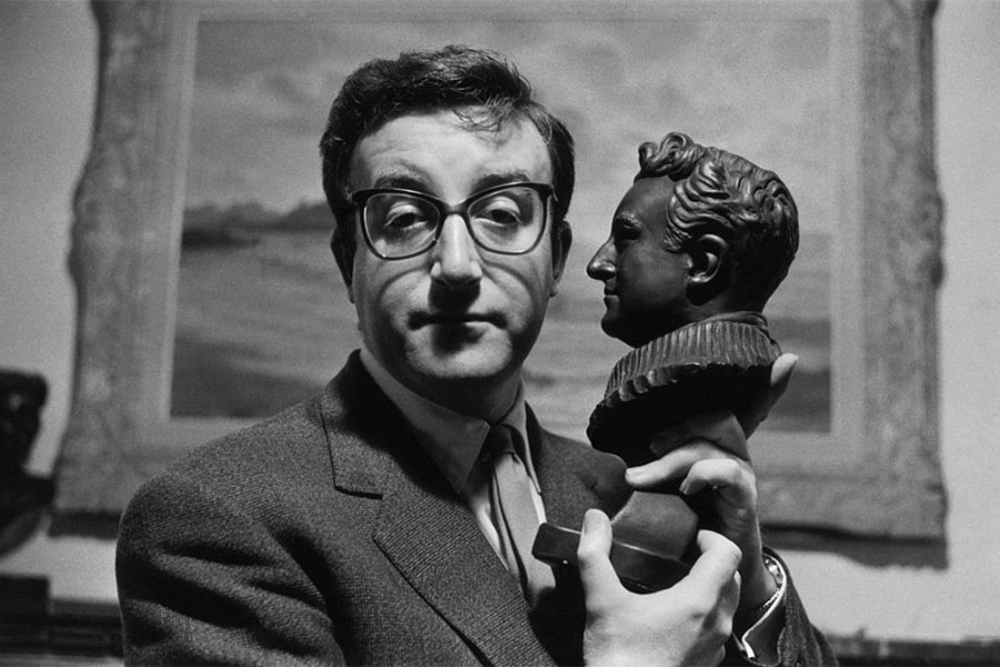 Peter Sellers holding a bust of himself.